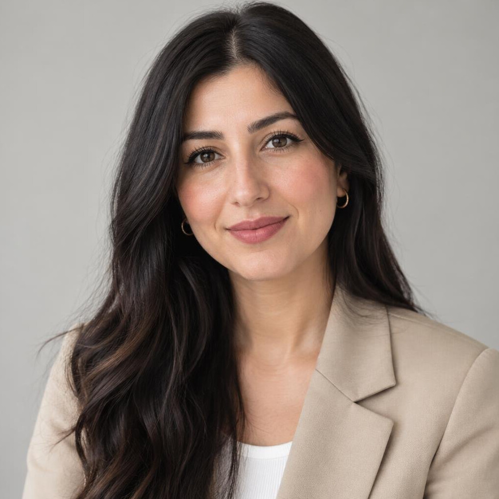 Portrait of a young woman of Turkish descent with long dark hair in a beige jacket